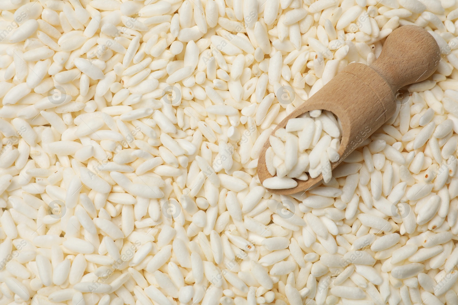 Photo of Scoop with puffed rice as background, closeup