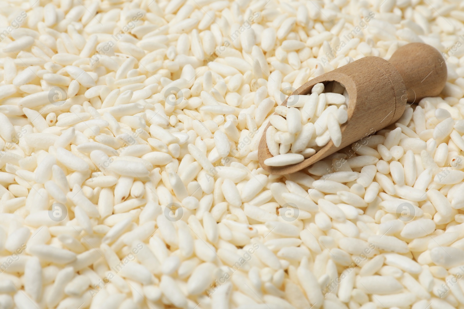 Photo of Scoop with puffed rice as background, closeup