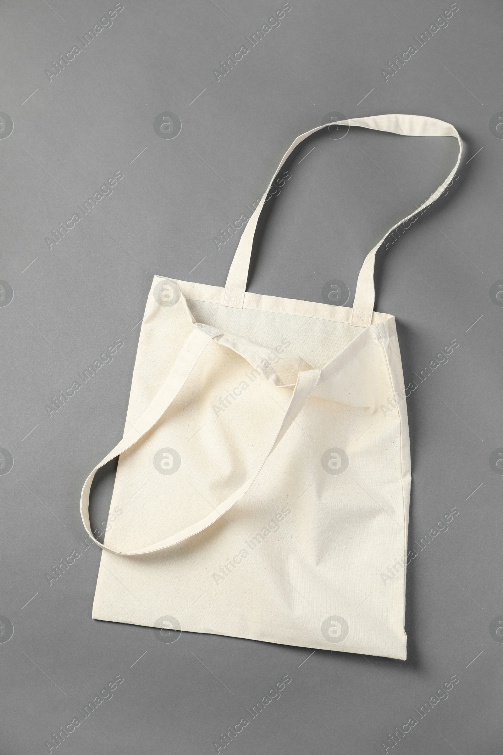 Photo of One shopping bag on grey background, top view. Mockup for design