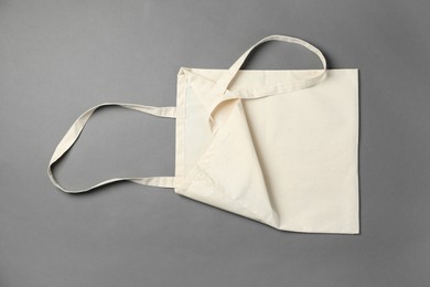 Photo of One shopping bag on grey background, top view. Mockup for design