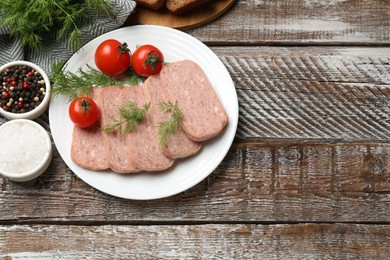 Photo of Tasty canned meat, tomatoes and spices on wooden table, flat lay. Space for text