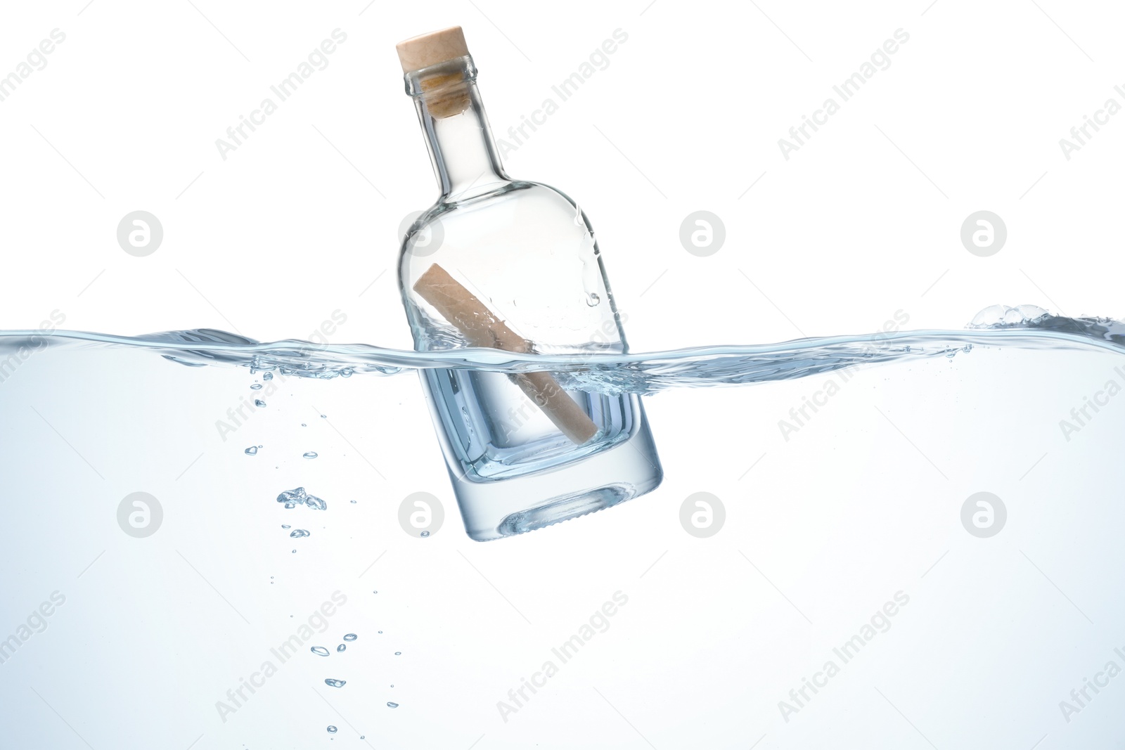 Photo of Corked glass bottle with rolled letter in water on white background