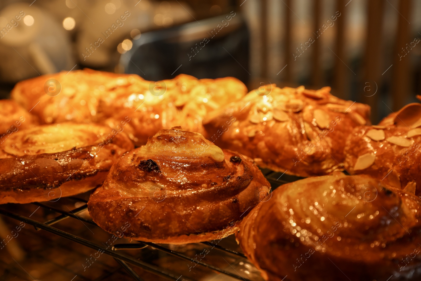 Photo of Delicious sweet roll buns on display in cafe, closeup