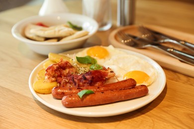 Photo of Delicious breakfast served on wooden table in restaurant, closeup