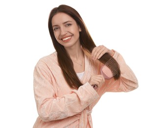 Photo of Smiling woman brushing her hair on white background