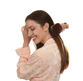 Photo of Smiling woman brushing her hair on white background