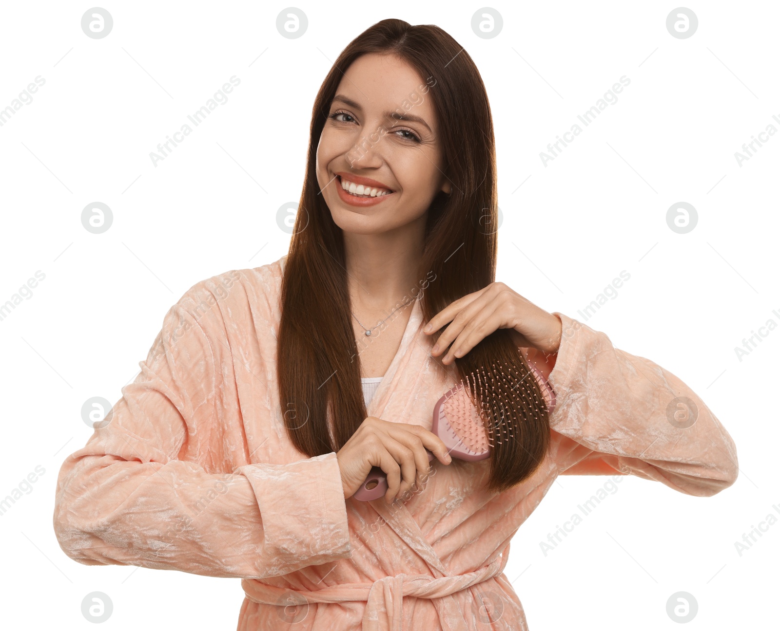 Photo of Smiling woman brushing her hair on white background