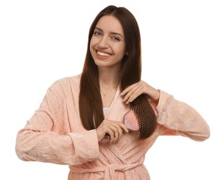 Photo of Smiling woman brushing her hair on white background