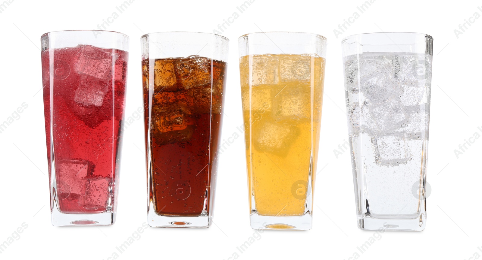 Photo of Soda water of different flavors with ice cubes in glasses isolated on white