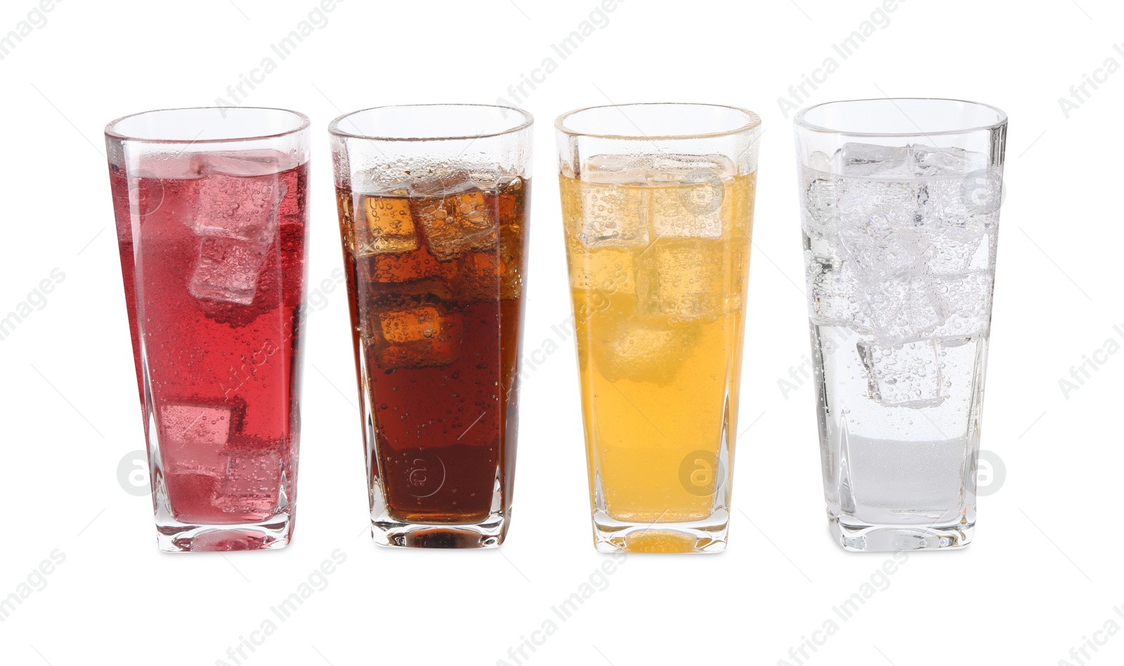 Photo of Soda water of different flavors with ice cubes in glasses isolated on white