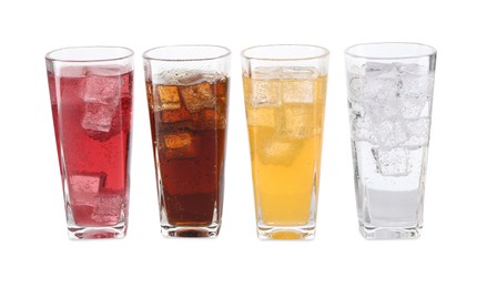 Photo of Soda water of different flavors with ice cubes in glasses isolated on white