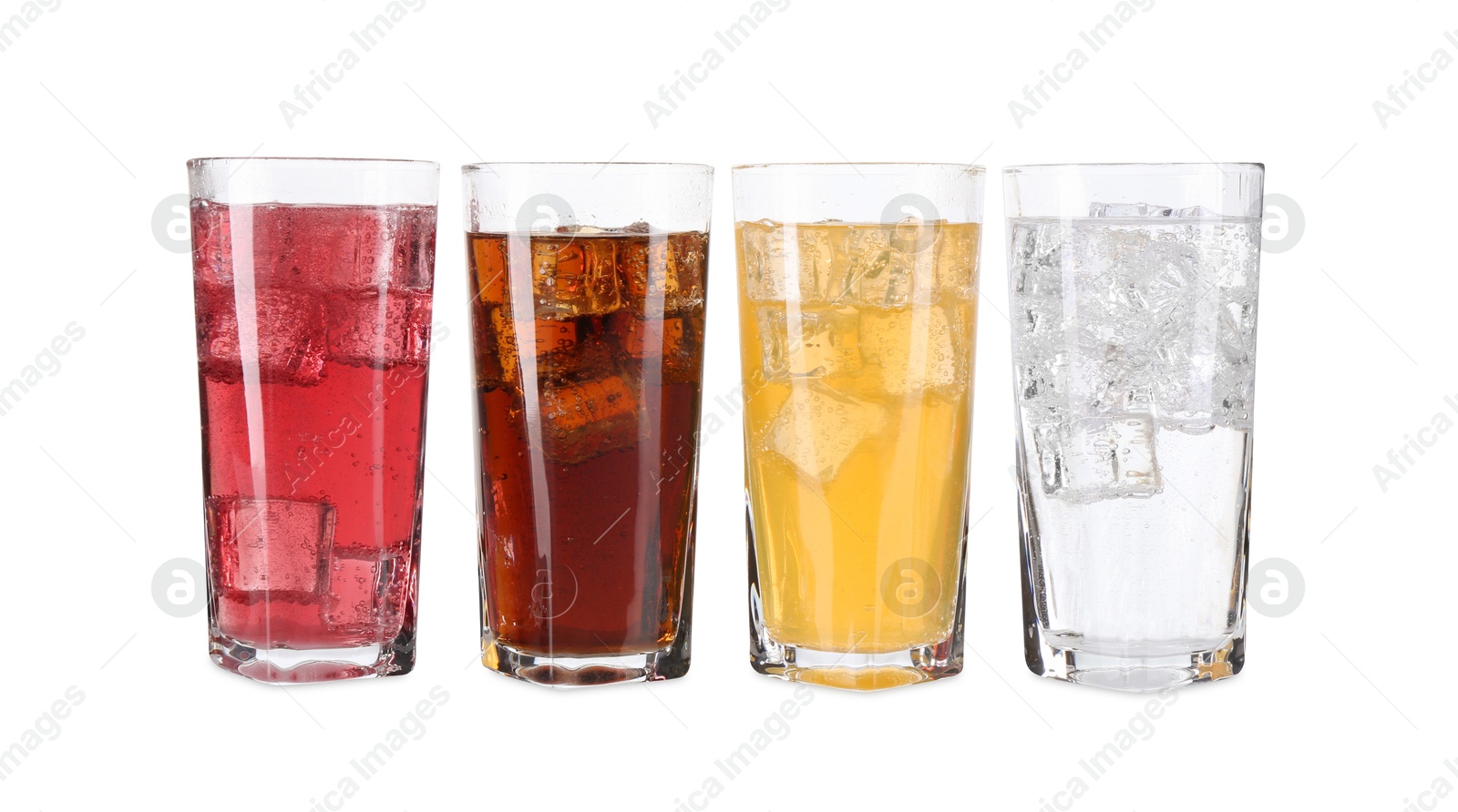 Photo of Soda water of different flavors with ice cubes in glasses isolated on white