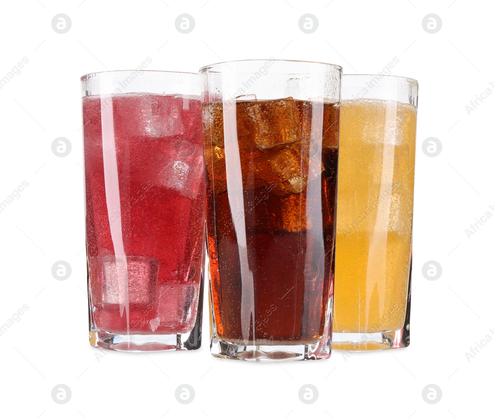 Photo of Soda water of different flavors with ice cubes in glasses isolated on white