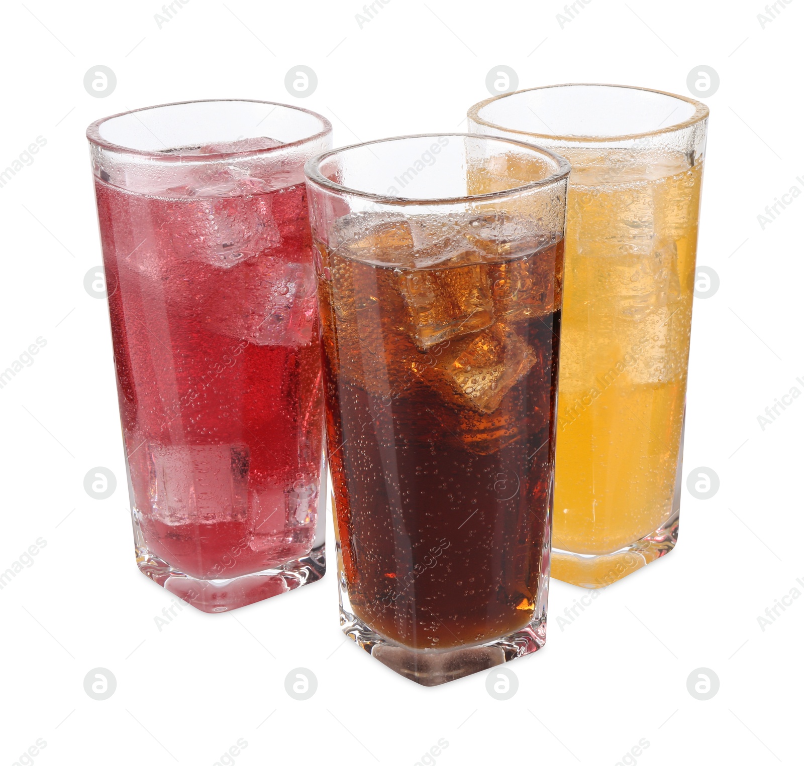 Photo of Soda water of different flavors with ice cubes in glasses isolated on white