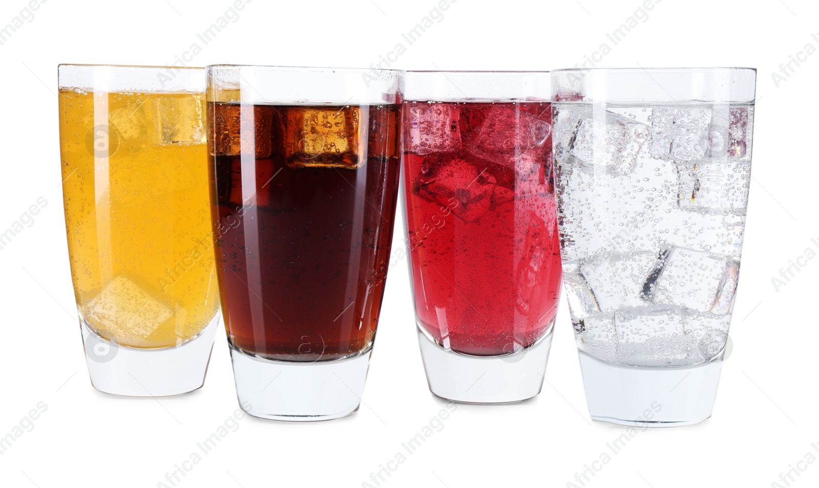 Photo of Soda water of different flavors with ice cubes in glasses isolated on white