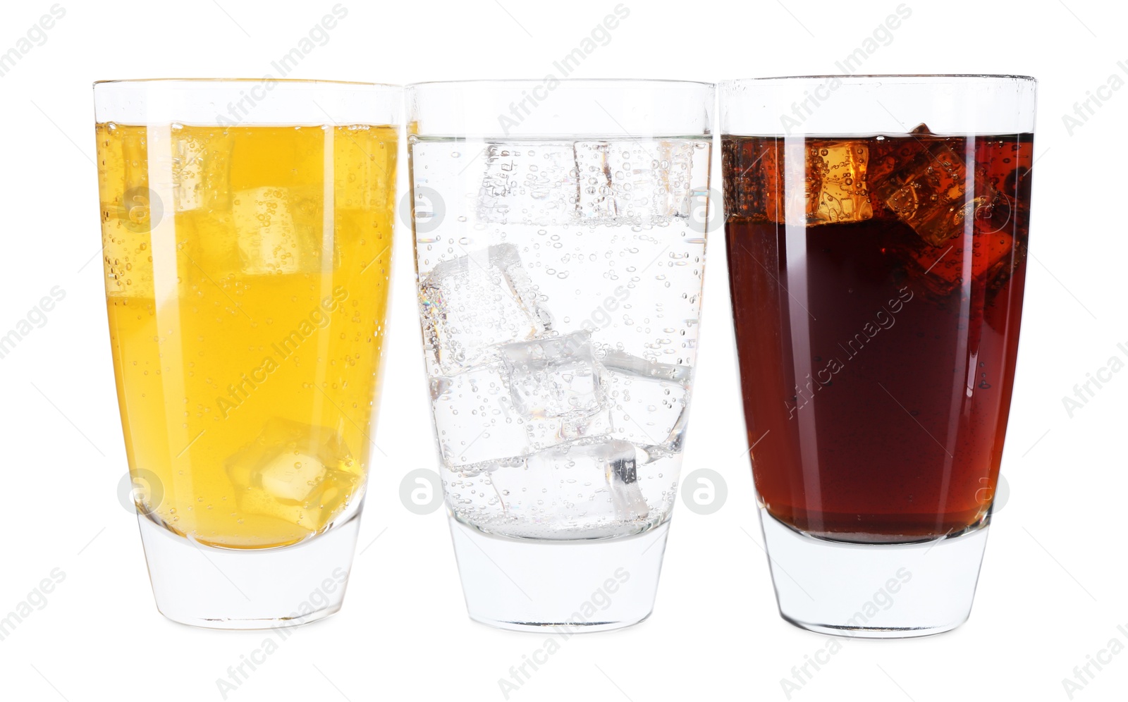 Photo of Soda water of different flavors with ice cubes in glasses isolated on white