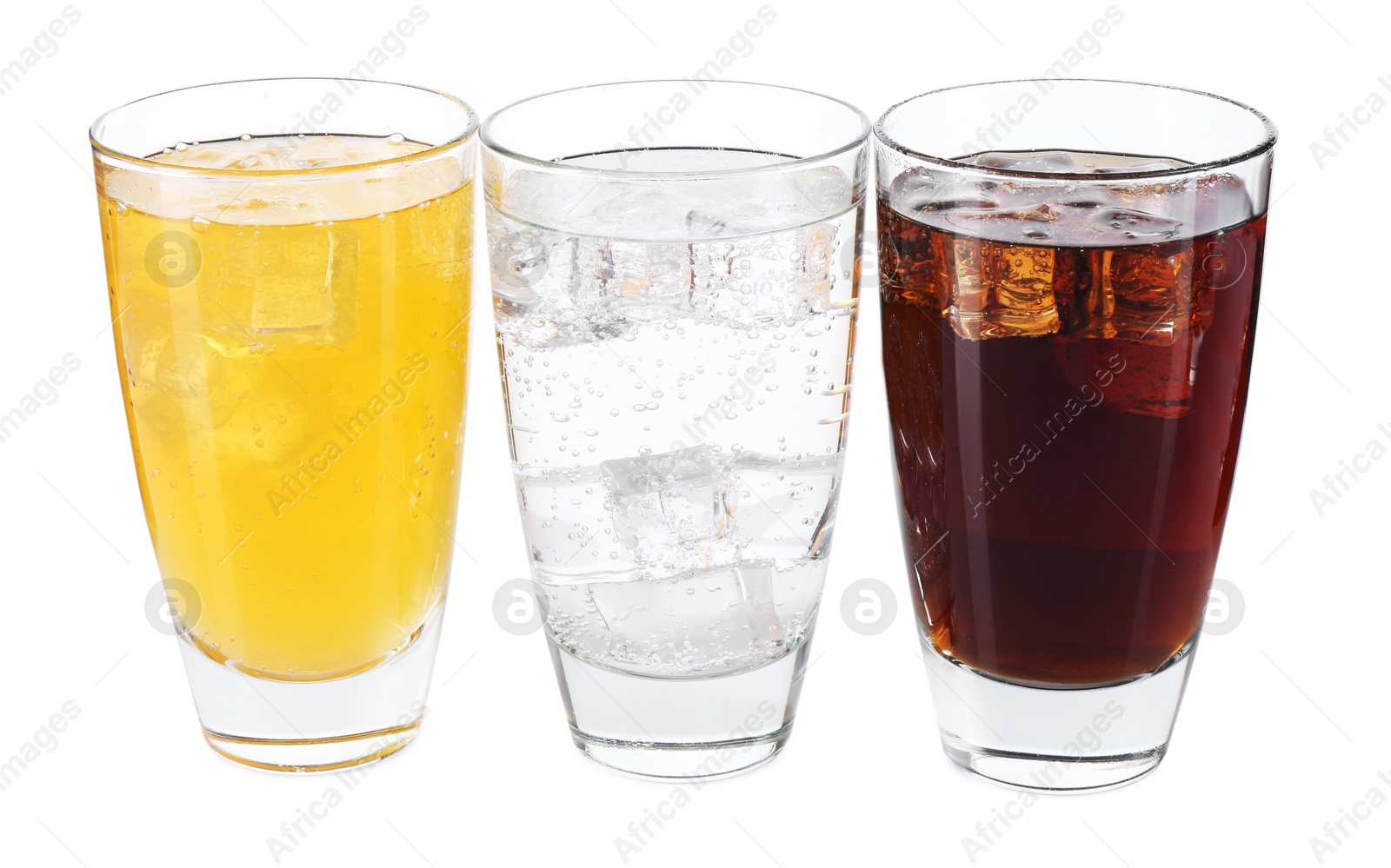 Photo of Soda water of different flavors with ice cubes in glasses isolated on white