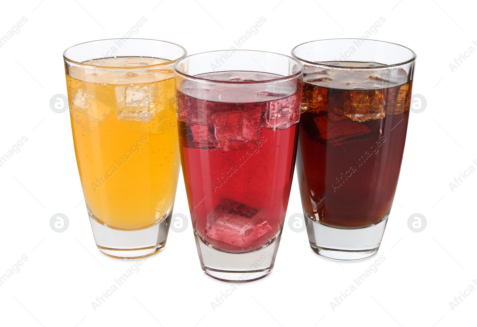 Photo of Soda water of different flavors with ice cubes in glasses isolated on white