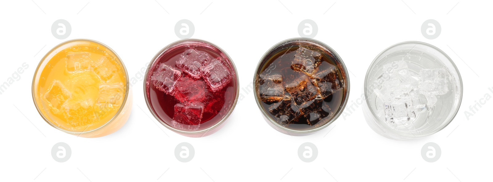 Photo of Soda water of different flavors with ice cubes in glasses isolated on white, top view