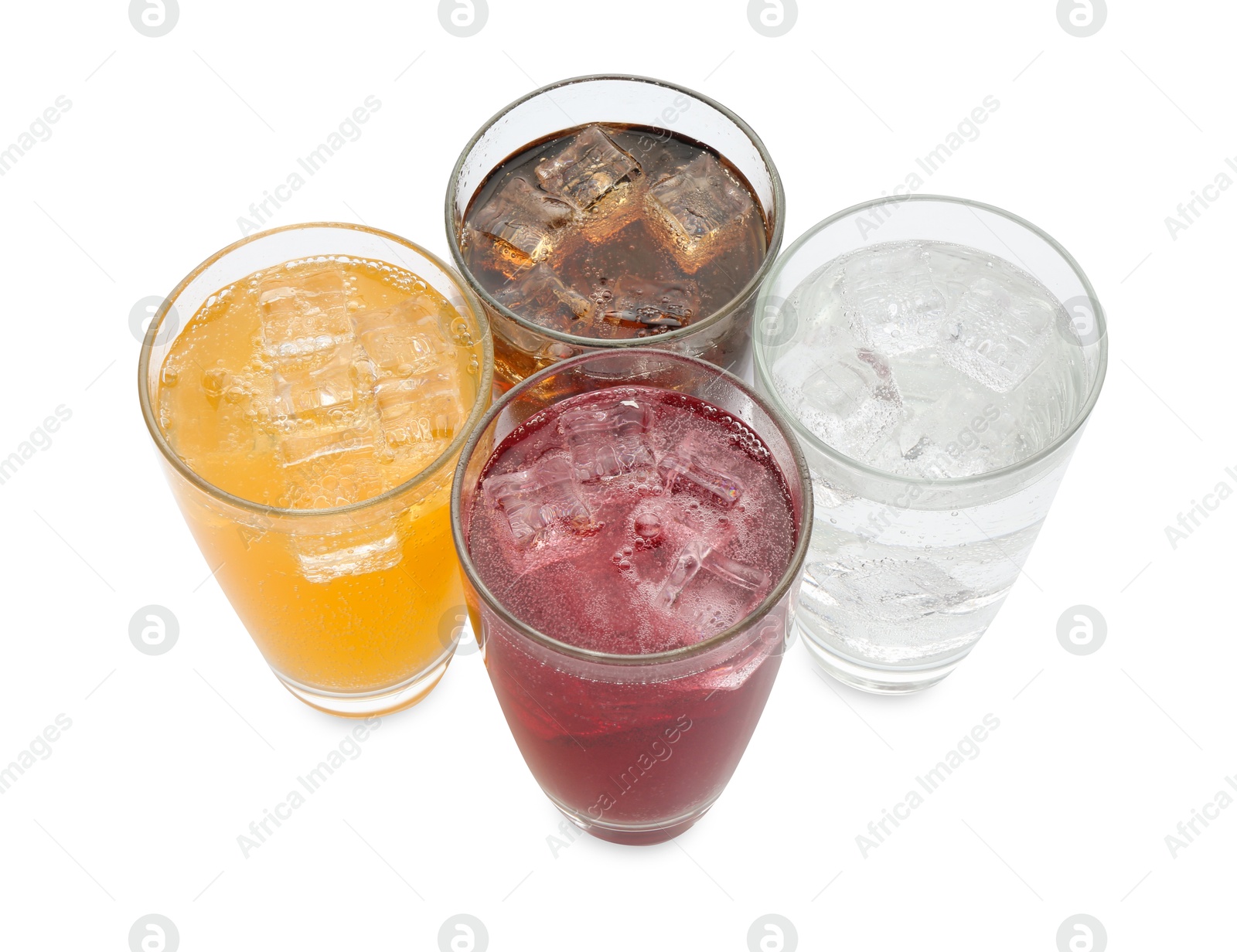 Photo of Soda water of different flavors with ice cubes in glasses isolated on white