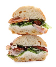 Photo of Delicious sandwiches with prosciutto and sun dried tomatoes isolated on white