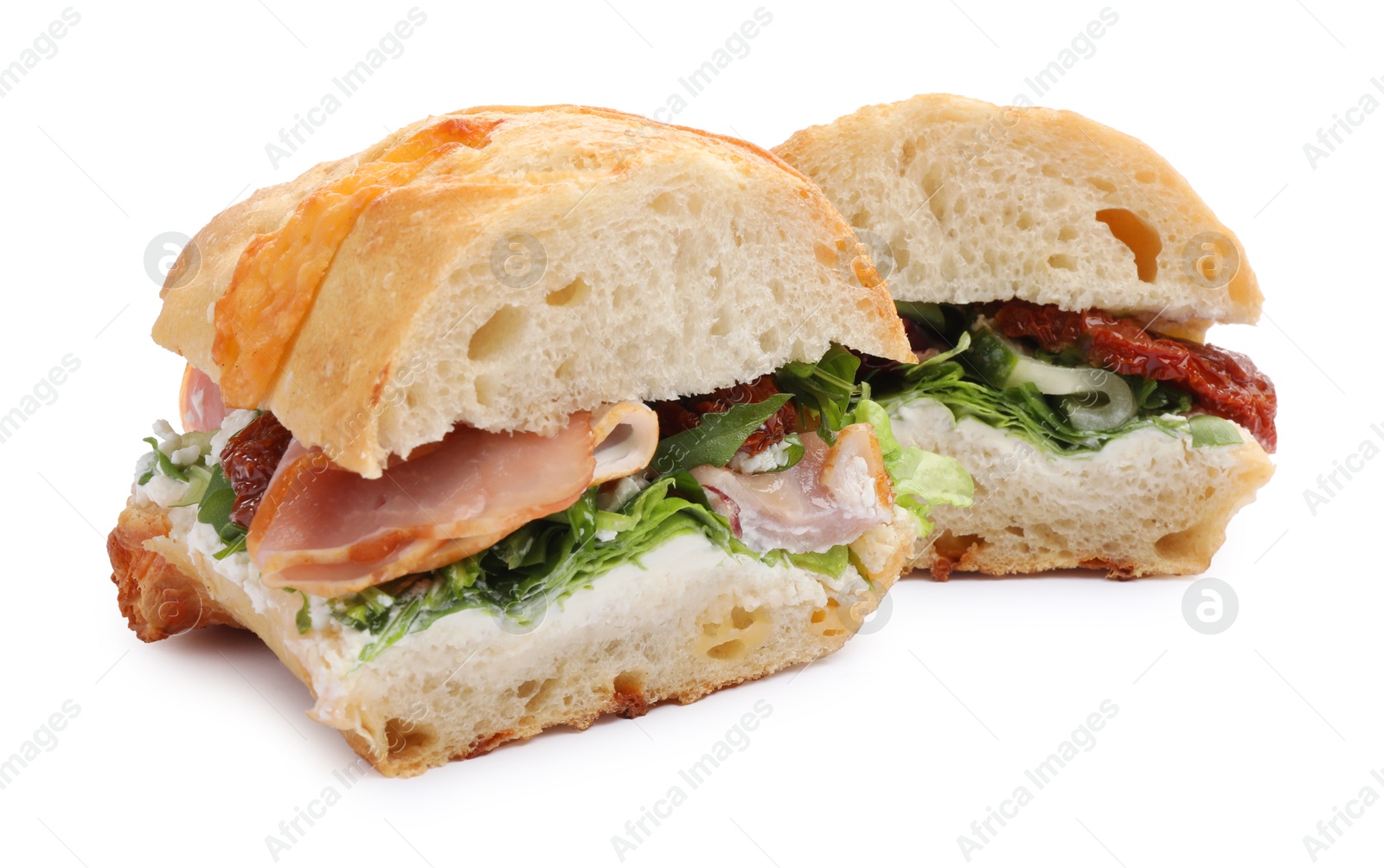 Photo of Delicious sandwiches with prosciutto and sun dried tomatoes isolated on white