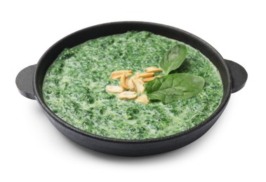 Photo of Delicious spinach sauce with peanuts in frying pan isolated on white