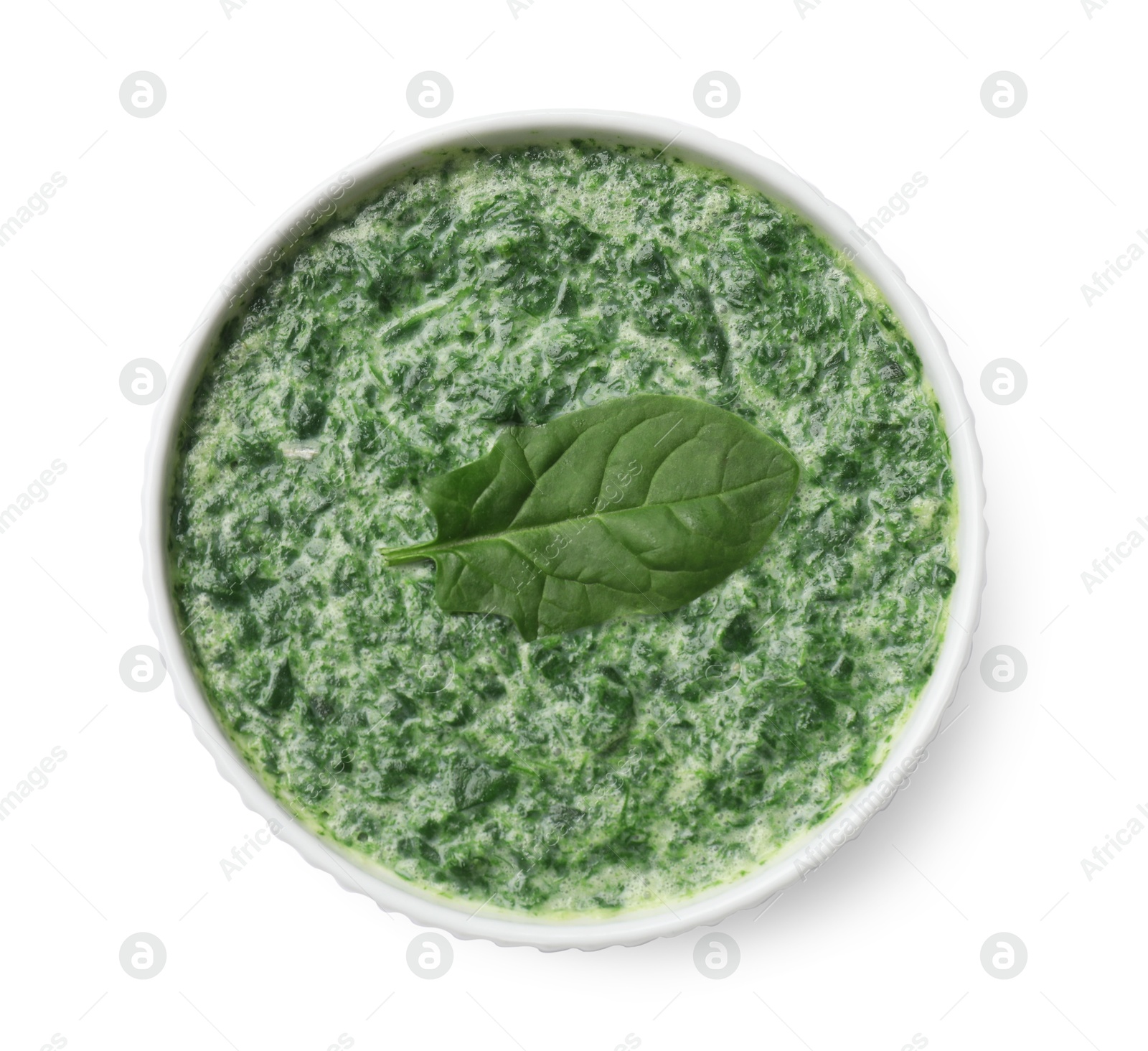 Photo of Delicious spinach sauce in bowl isolated on white, top view