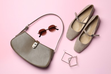 Photo of Beautiful bag, shoes and stylish accessories on light pink background, flat lay