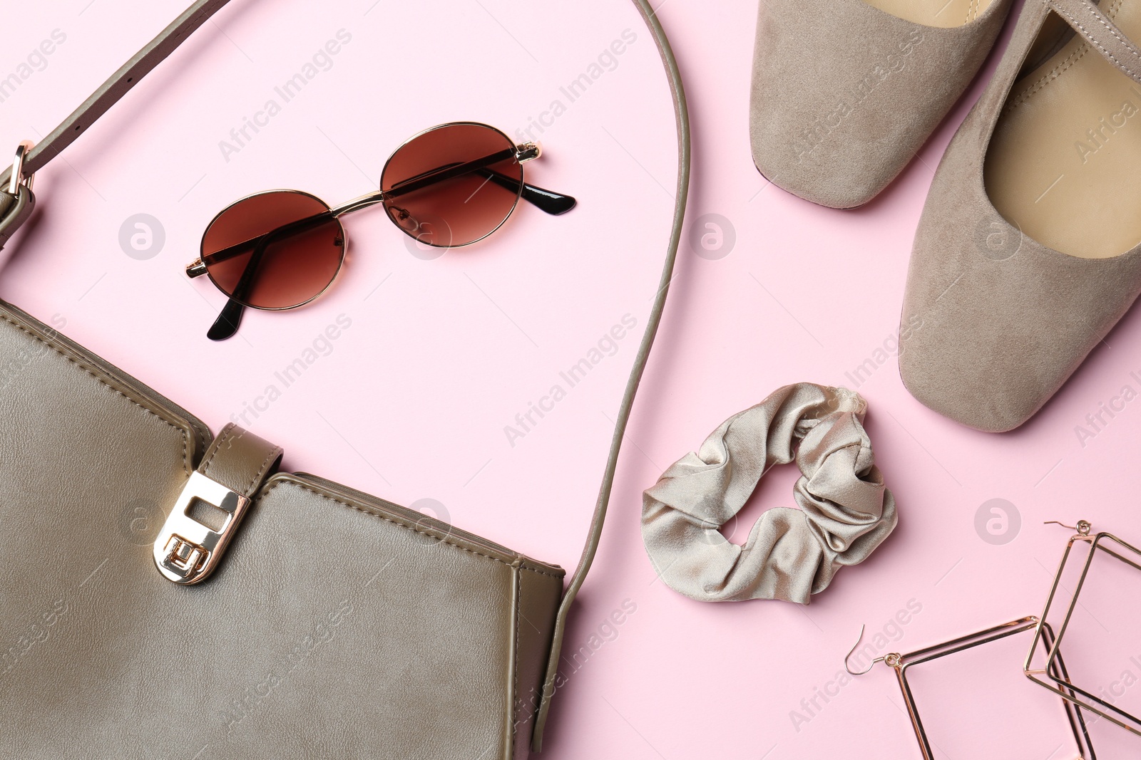 Photo of Beautiful bag, shoes and stylish accessories on light pink background, flat lay