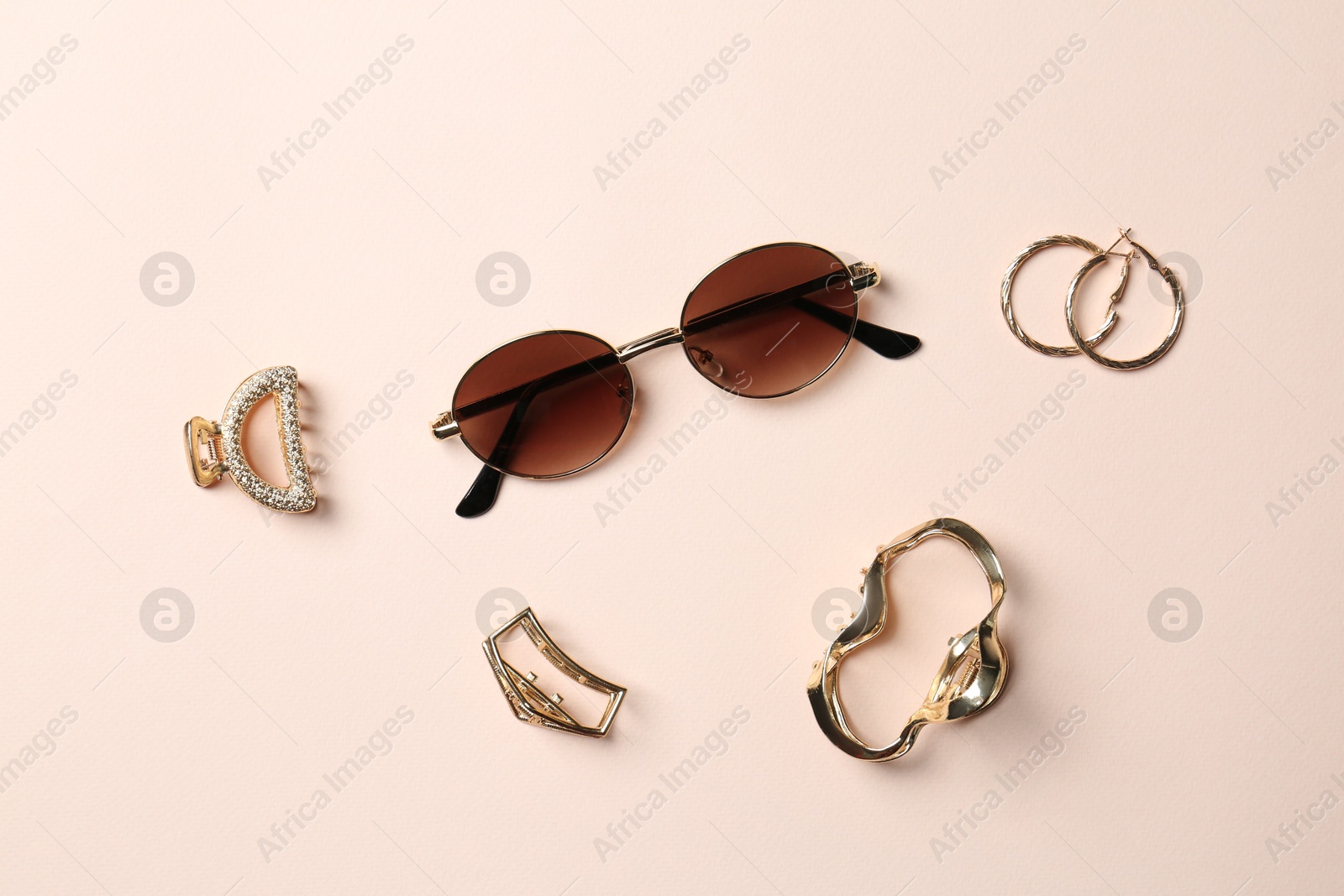 Photo of Stylish accessories on beige background, flat lay