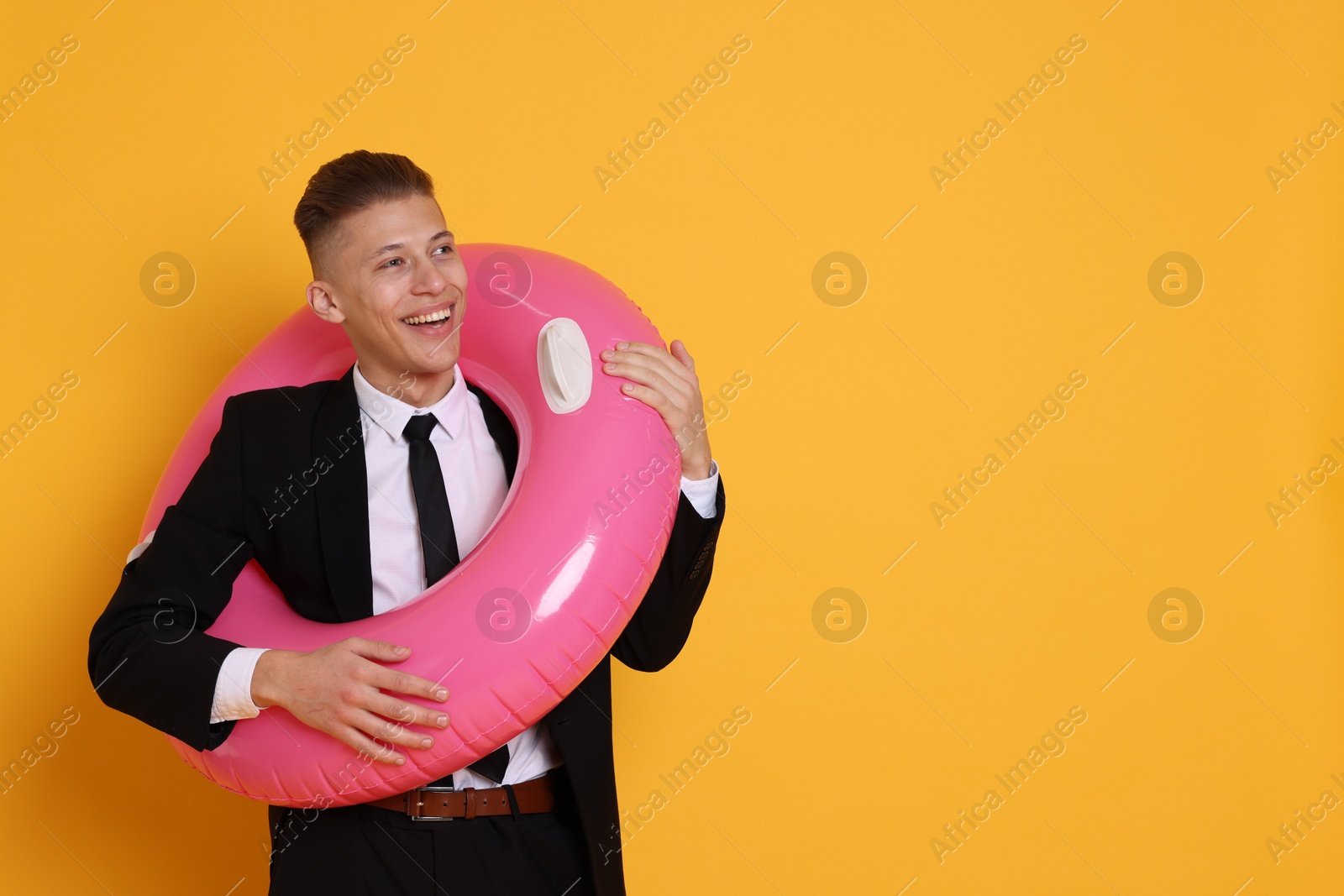 Photo of Businessman with inflatable ring on orange background, space for text