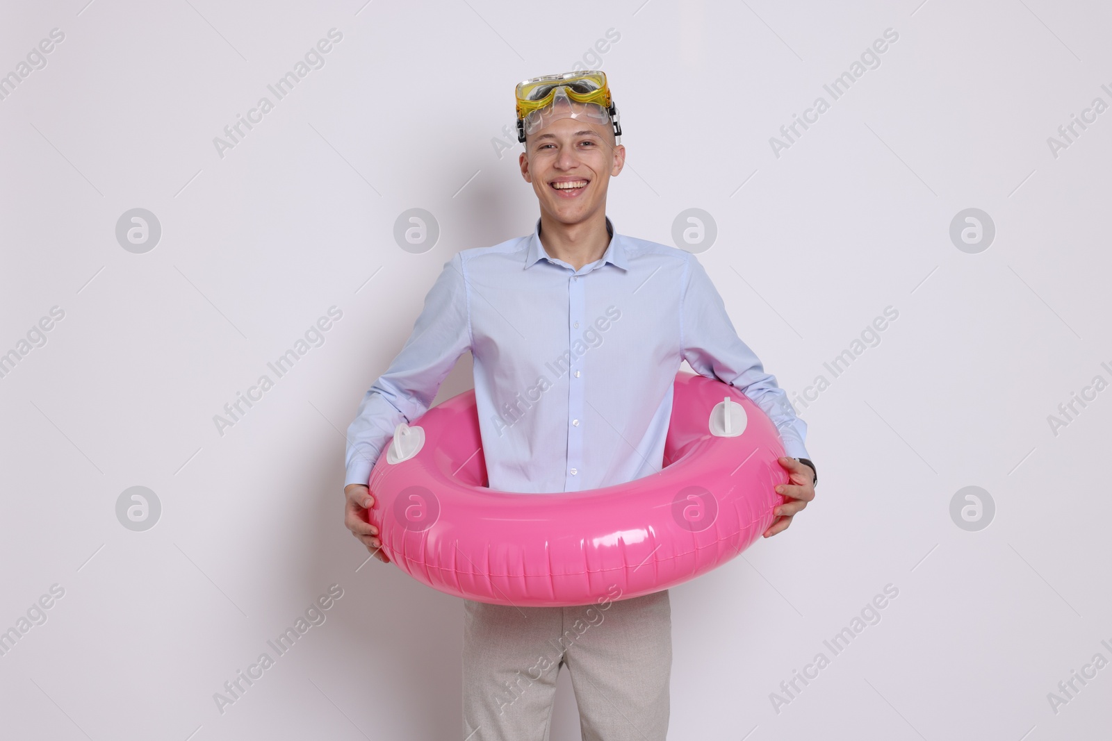 Photo of Businessman with inflatable ring and diving mask on white background