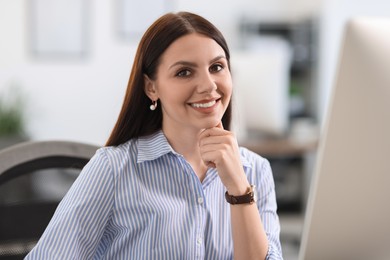 Photo of Portrait of happy banker in shirt at workplace