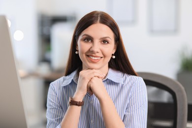 Photo of Portrait of happy banker in shirt at workplace