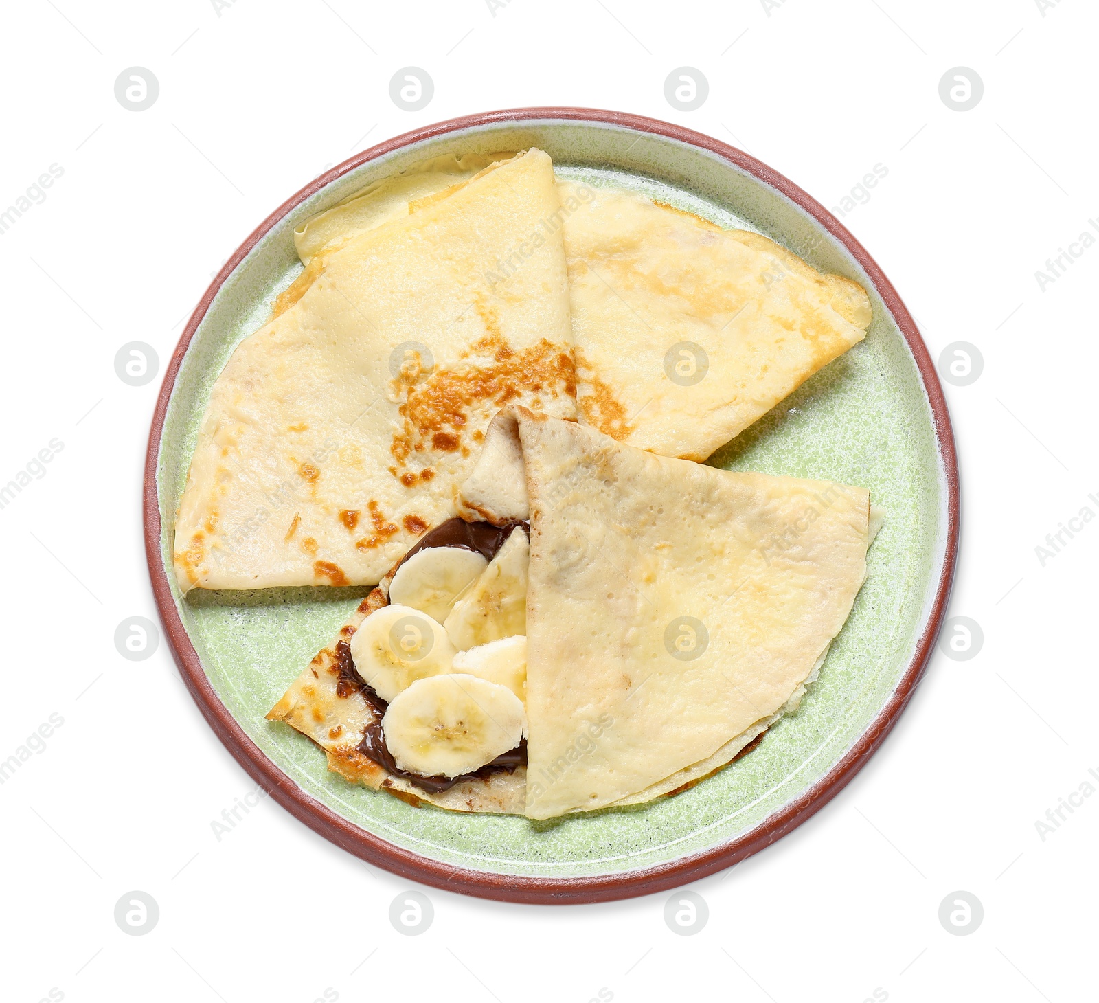 Photo of Delicious crepes with chocolate sauce and banana isolated on white, top view