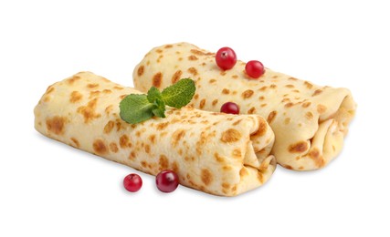 Photo of Delicious rolled crepes with cranberries and mint isolated on white