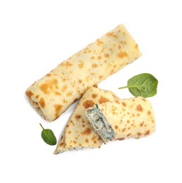 Photo of Tasty rolled crepes with cottage cheese and spinach isolated on white, top view