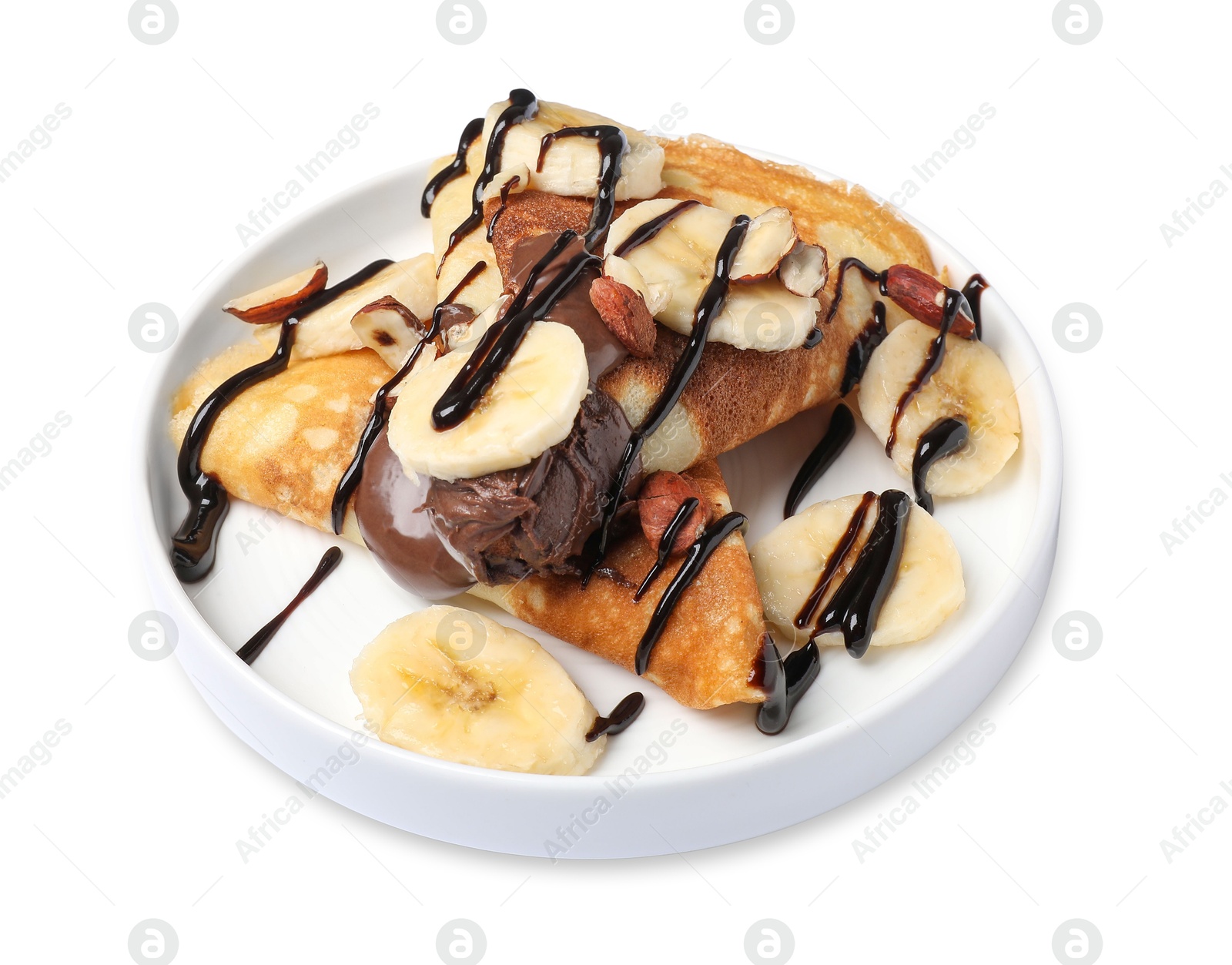 Photo of Delicious crepes with banana, nuts and chocolate sauce isolated on white