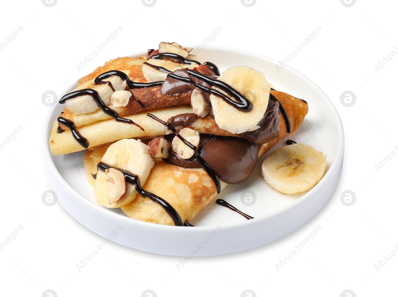 Photo of Delicious crepes with banana, nuts and chocolate sauce isolated on white