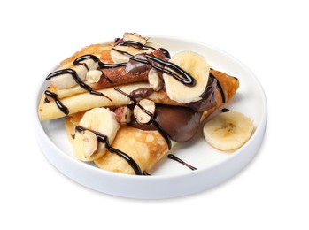 Photo of Delicious crepes with banana, nuts and chocolate sauce isolated on white