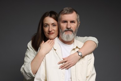 Photo of Daughter hugging her father on dark background