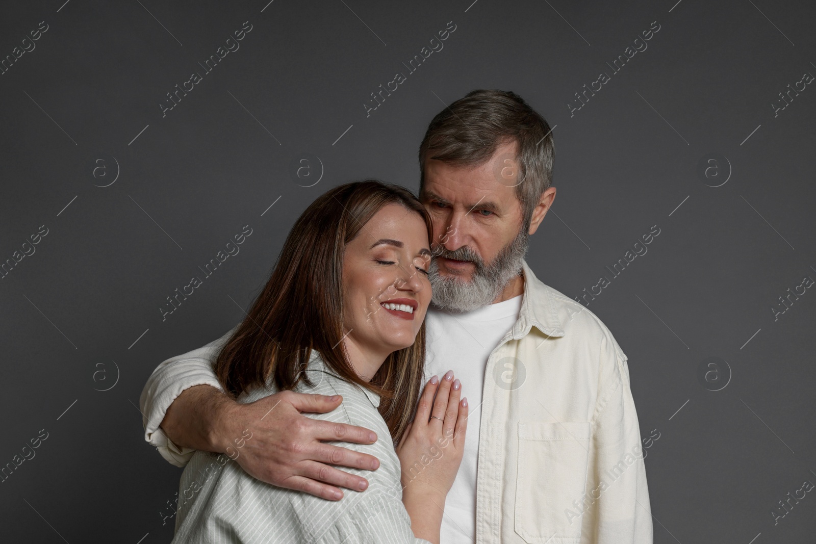 Photo of Father hugging his daughter on dark background