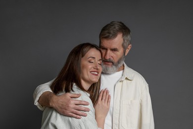 Photo of Father hugging his daughter on dark background