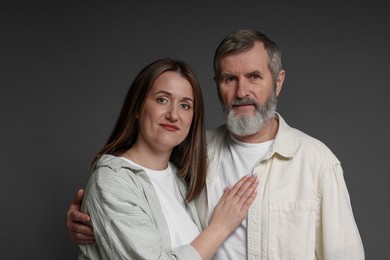 Photo of Family portrait of daughter and her father on dark background