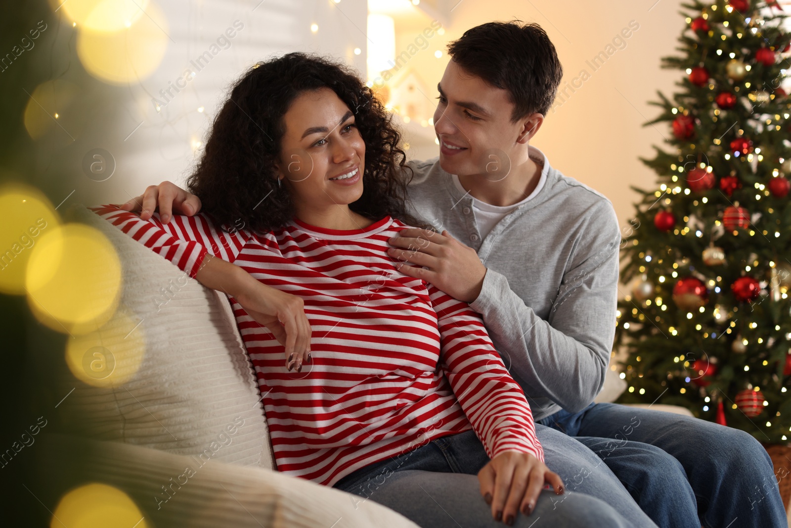 Photo of Happy couple spending time together at home. Christmas celebration