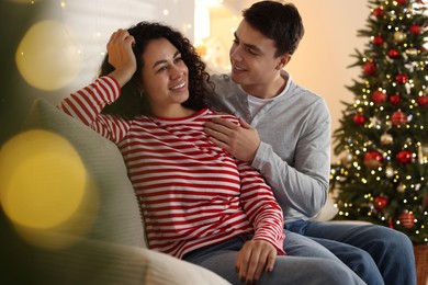 Photo of Happy couple spending time together at home. Christmas celebration