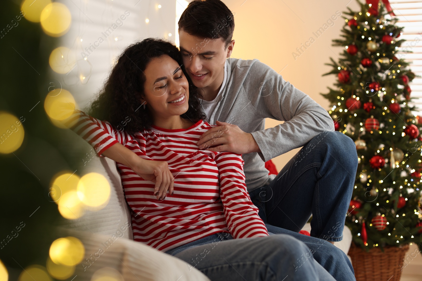 Photo of Happy couple spending time together at home. Christmas celebration