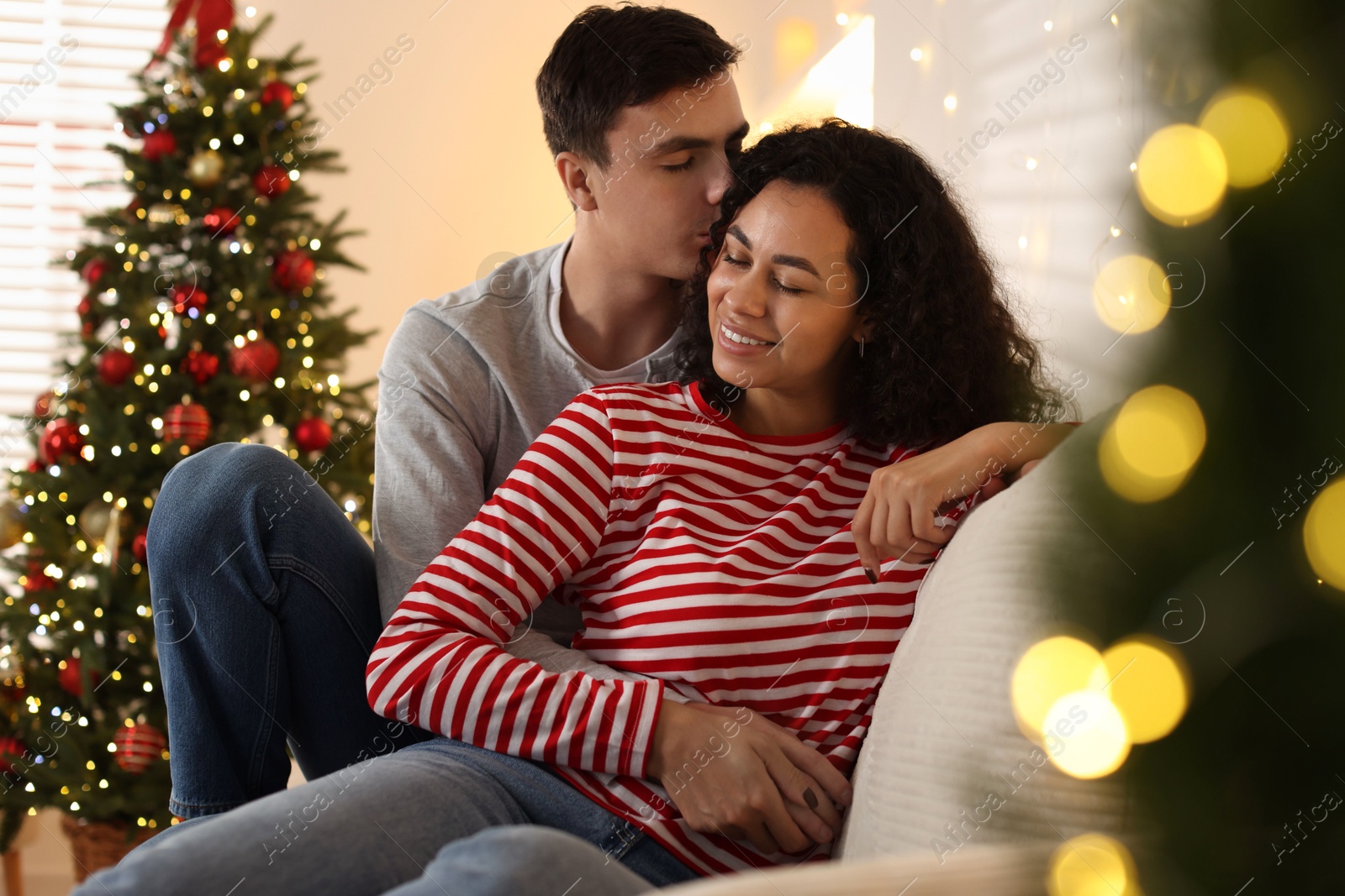 Photo of Happy couple spending time together at home. Christmas celebration