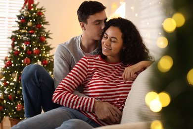 Photo of Happy couple spending time together at home. Christmas celebration